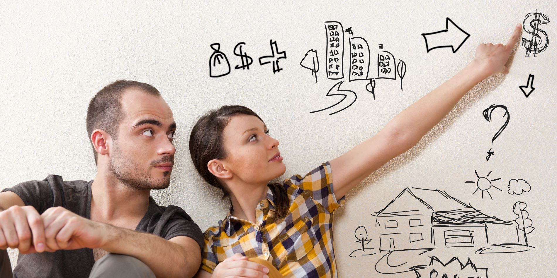 Pareja piensa en comprar una casa, están sentados en el suelo y generan un plan de ahorros para lograr sus objetivos financieros.